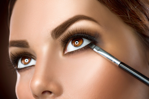 Woman applying makeup closeup. Eyeliner make up